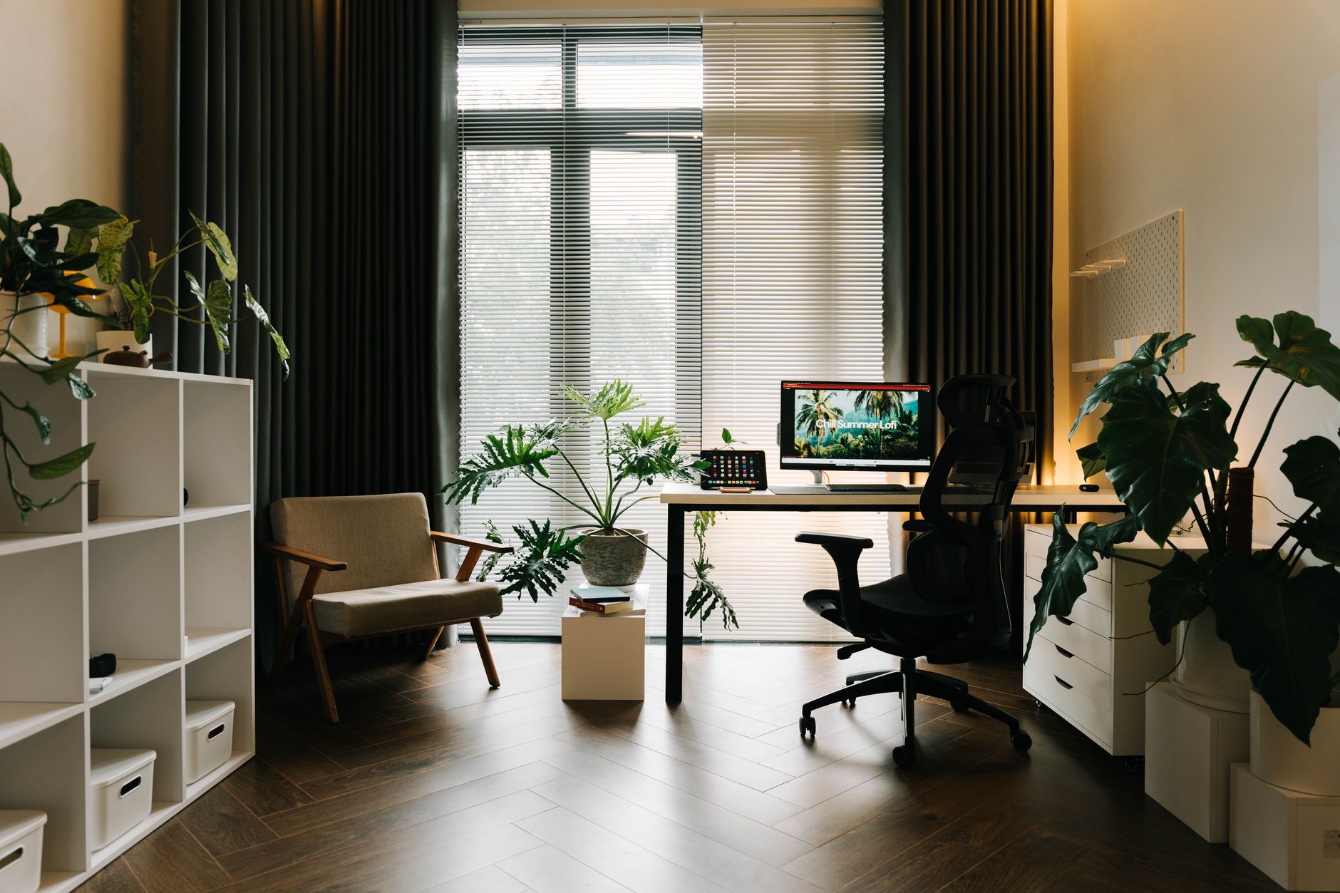 Stylish home office with modern furniture and lush greenery.